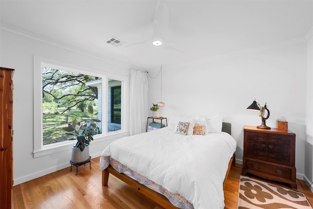 bedroom featuring crown molding, baseboards, and multiple windows
