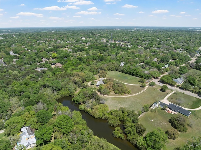 aerial view with a water view and a wooded view