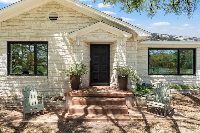 entrance to property with stone siding