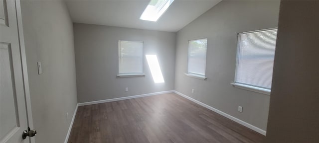 103 Lorie St, Alvarado, TX 76009 - unfurnished room featuring baseboards, wood finished floors, and vaulted ceiling with skylight
