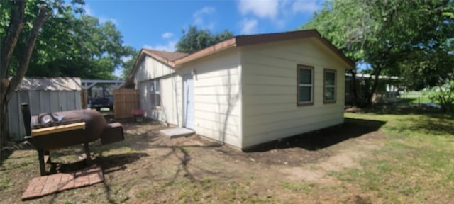103 Lorie St, Alvarado, TX 76009 - view of side of home with an outdoor structure and a storage unit