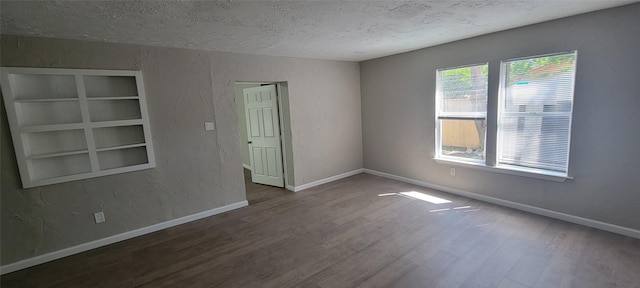 103 Lorie St, Alvarado, TX 76009 - spare room with baseboards, a textured wall, wood finished floors, and a textured ceiling