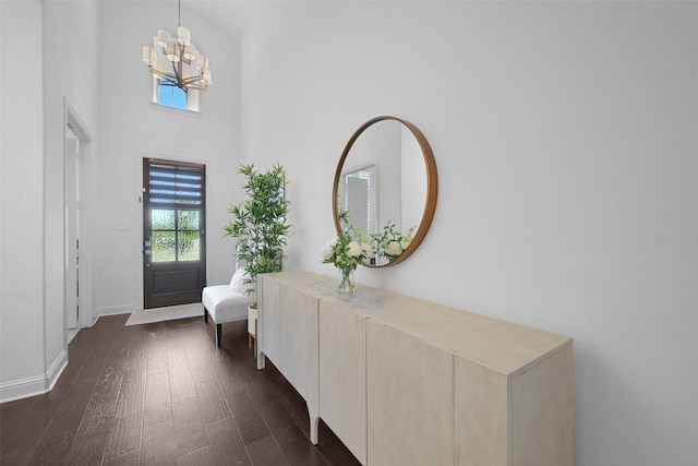 731 Drummond Dr, Prosper, TX 75078 - foyer with dark wood-type flooring, a high ceiling, baseboards, and an inviting chandelier