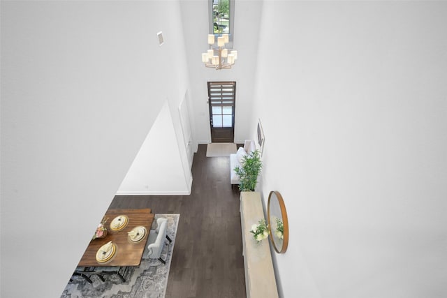 731 Drummond Dr, Prosper, TX 75078 - staircase featuring wood finished floors, a chandelier, baseboards, and a towering ceiling