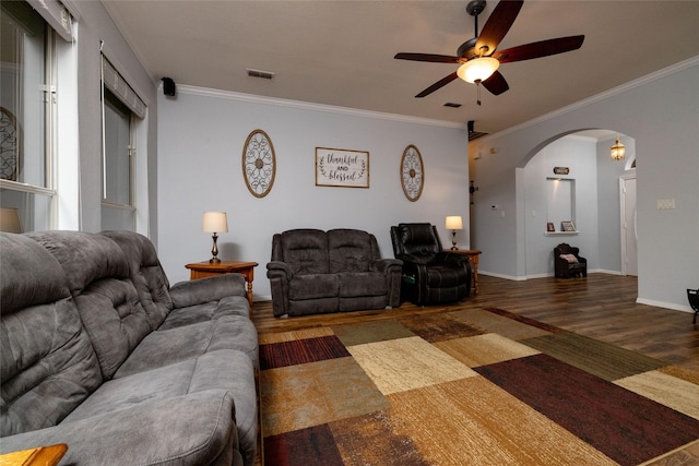 516 Hazelnut Ct, Saginaw, TX 76179 - living room with arched walkways, wood finished floors, a ceiling fan, ornamental molding, and baseboards