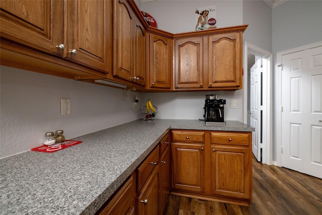 516 Hazelnut Ct, Saginaw, TX 76179 - kitchen with dark wood-style flooring, brown cabinets, and crown molding