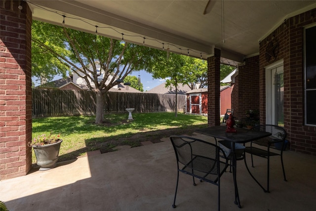 516 Hazelnut Ct, Saginaw, TX 76179 - view of patio featuring a storage shed, outdoor dining space, an outbuilding, and ceiling fan