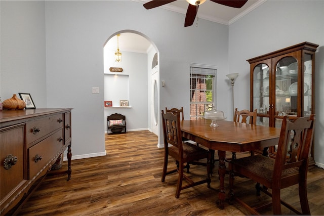 516 Hazelnut Ct, Saginaw, TX 76179 - dining area with ornamental molding, a ceiling fan, arched walkways, dark wood-type flooring, and baseboards