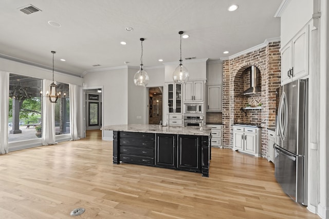 1005 Forest Lake Cir, Mckinney, TX 75072 - kitchen with stainless steel appliances, a chandelier, wall chimney exhaust hood, light wood-style flooring, and recessed lighting