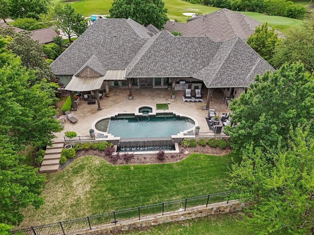 view of swimming pool featuring a fenced backyard, view of golf course, a lawn, and a patio