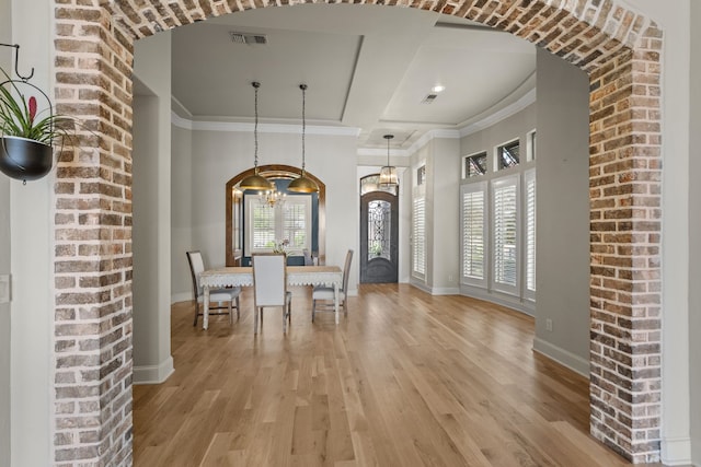1005 Forest Lake Cir, Mckinney, TX 75072 - dining space with arched walkways, light wood-style floors, baseboards, crown molding, and coffered ceiling