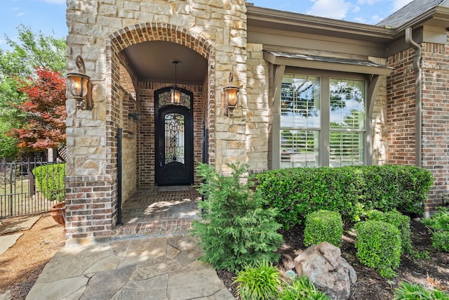 1005 Forest Lake Cir, Mckinney, TX 75072 - doorway to property featuring brick siding, fence, and stone siding