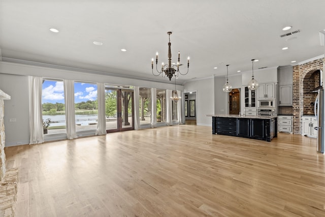 1005 Forest Lake Cir, Mckinney, TX 75072 - unfurnished living room with a chandelier, ornamental molding, recessed lighting, a water view, and baseboards