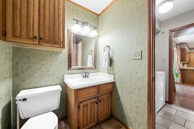 bathroom with toilet, vanity, and tile patterned floors