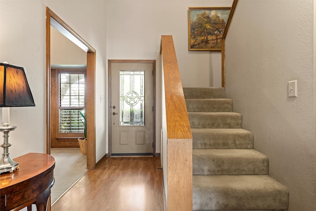 foyer entrance featuring stairs and wood finished floors