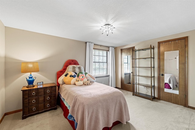 bedroom with light carpet and baseboards