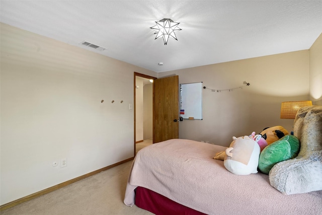 carpeted bedroom featuring visible vents and baseboards
