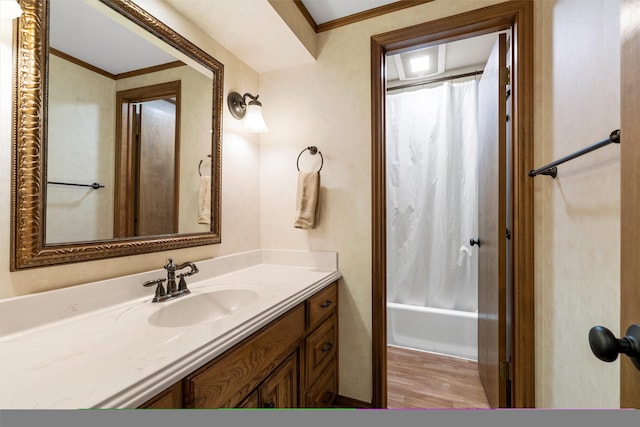 bathroom with shower / bath combo, wood finished floors, vanity, and ornamental molding
