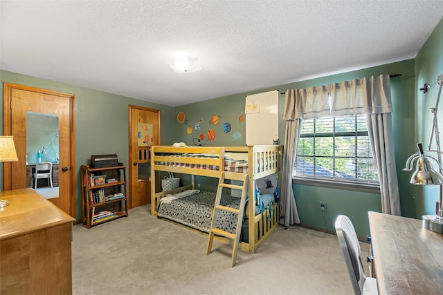 bedroom with carpet flooring and a textured ceiling