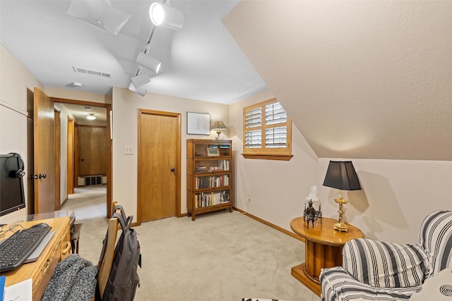 interior space featuring baseboards, visible vents, and light colored carpet