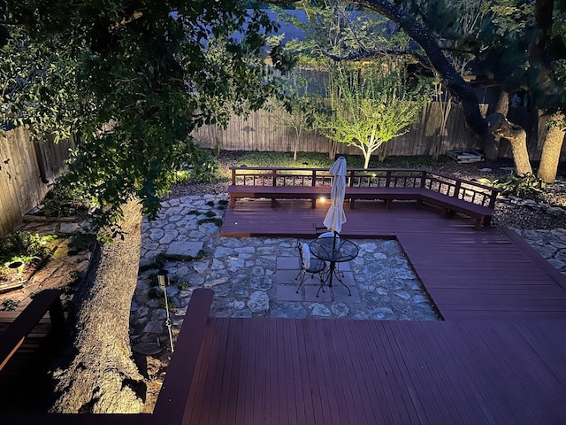 wooden deck with a fenced backyard