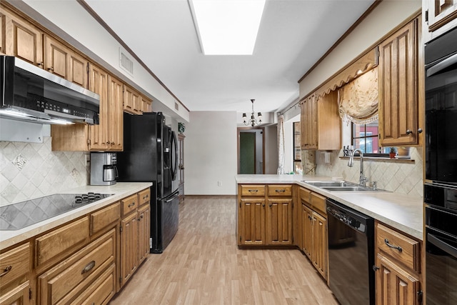 kitchen featuring a sink, visible vents, a notable chandelier, brown cabinets, and black appliances