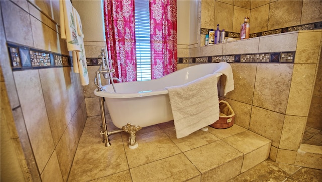 full bathroom featuring a soaking tub and tile walls