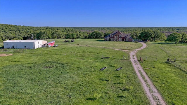 birds eye view of property with a rural view and a wooded view