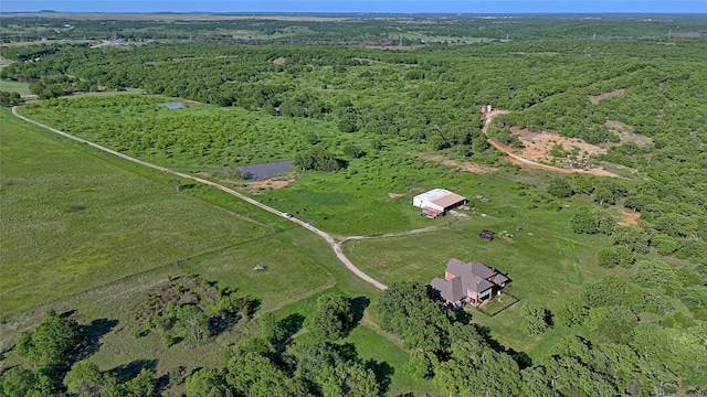 drone / aerial view featuring a rural view and a view of trees