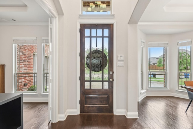 13002 Clarendon Dr, Frisco, TX 75035 - foyer entrance with baseboards, ornamental molding, dark wood-style floors, and arched walkways