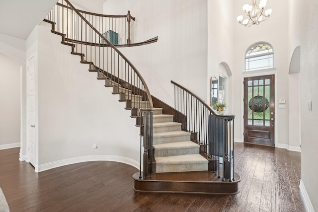 13002 Clarendon Dr, Frisco, TX 75035 - foyer entrance with a notable chandelier, hardwood / wood-style floors, a towering ceiling, and stairway