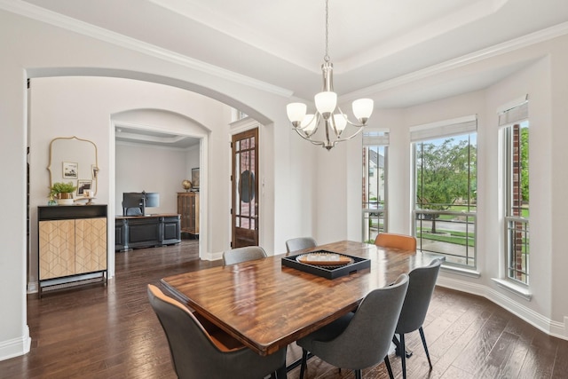 13002 Clarendon Dr, Frisco, TX 75035 - dining room featuring ornamental molding, dark wood-type flooring, a chandelier, arched walkways, and baseboards