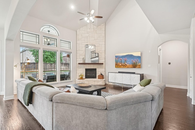 13002 Clarendon Dr, Frisco, TX 75035 - living room with high vaulted ceiling, dark wood finished floors, ceiling fan, arched walkways, and baseboards
