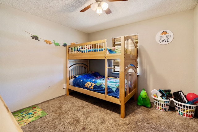 carpeted bedroom featuring ceiling fan and a textured ceiling