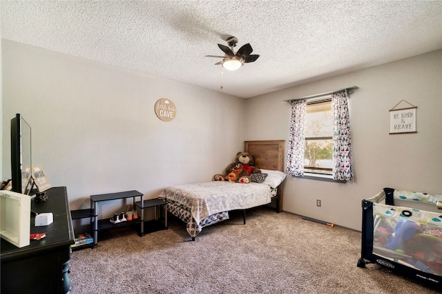 bedroom with carpet floors, a textured ceiling, and ceiling fan