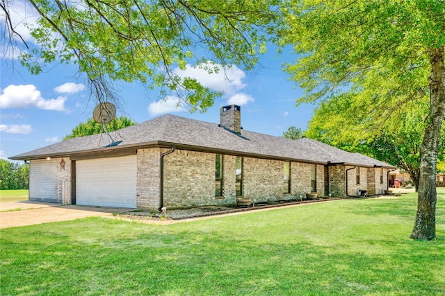 view of side of property with a chimney, a yard, concrete driveway, an attached garage, and brick siding