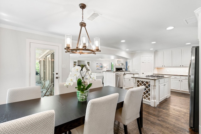 6726 Williamson Rd, Dallas, TX 75214 - dining room featuring a chandelier, dark wood-style flooring, crown molding, and recessed lighting