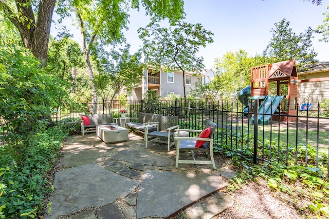 6726 Williamson Rd, Dallas, TX 75214 - view of patio / terrace with fence, a playground, and an outdoor living space with a fire pit