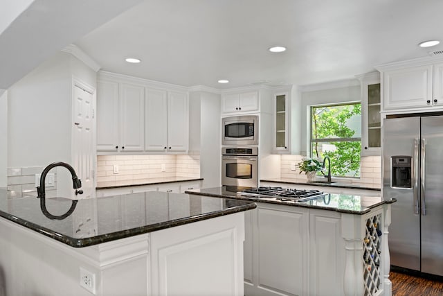 6726 Williamson Rd, Dallas, TX 75214 - kitchen with appliances with stainless steel finishes, white cabinetry, glass insert cabinets, recessed lighting, and dark stone countertops