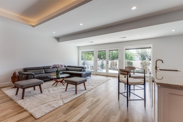 living room with french doors, recessed lighting, light wood-style flooring, and visible vents
