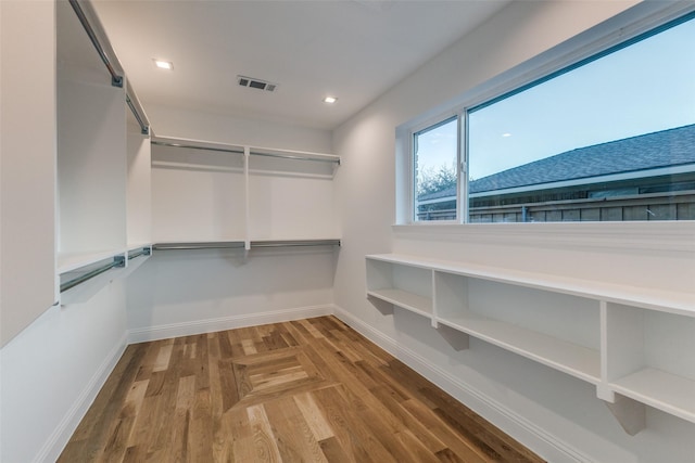 spacious closet featuring visible vents and wood finished floors