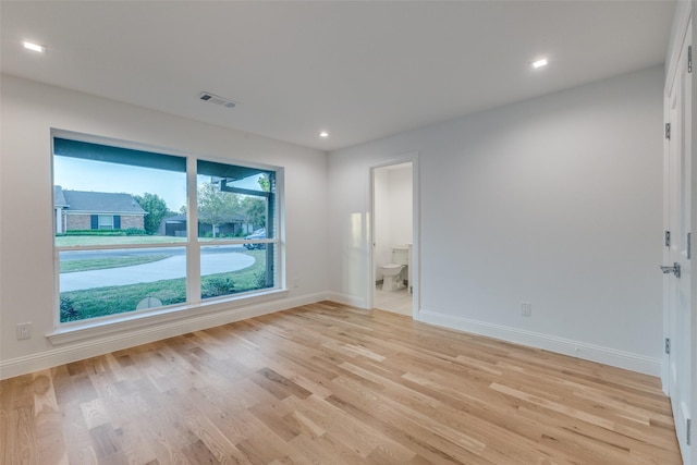 spare room with visible vents, baseboards, and light wood-type flooring