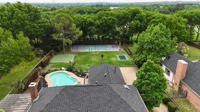 drone / aerial view featuring a view of trees