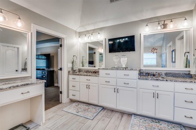 full bathroom featuring visible vents, wood finished floors, and vanity