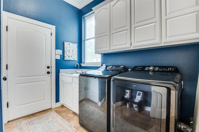 clothes washing area featuring a sink, baseboards, separate washer and dryer, cabinet space, and ornamental molding