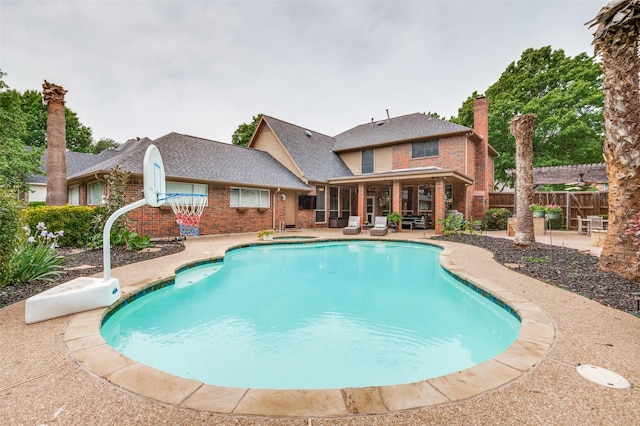 view of swimming pool featuring fence, a fenced in pool, and a patio