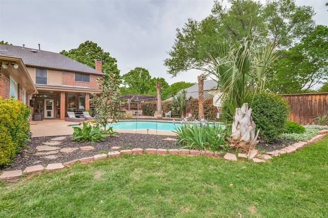 view of swimming pool with a fenced backyard, a patio, a fenced in pool, and a lawn