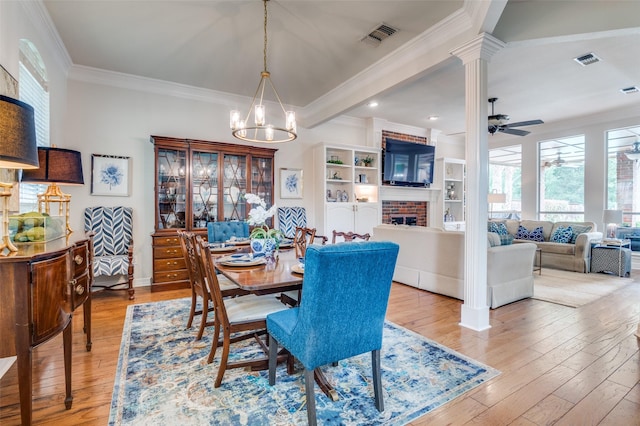 dining space with a wealth of natural light, visible vents, and a fireplace