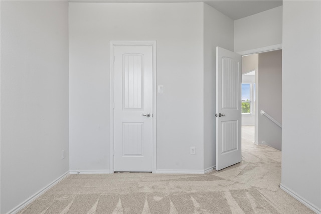 unfurnished bedroom with baseboards and carpet