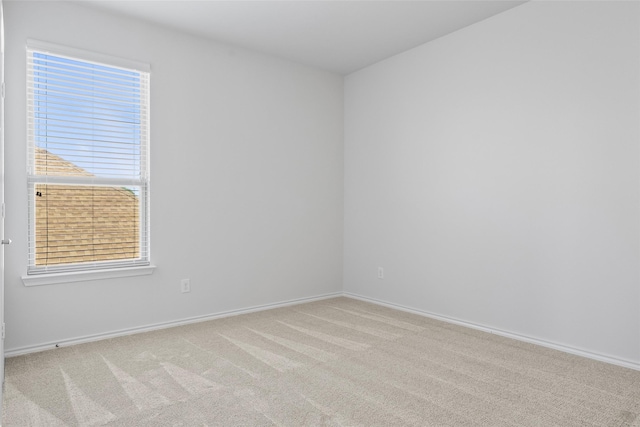 carpeted spare room with baseboards